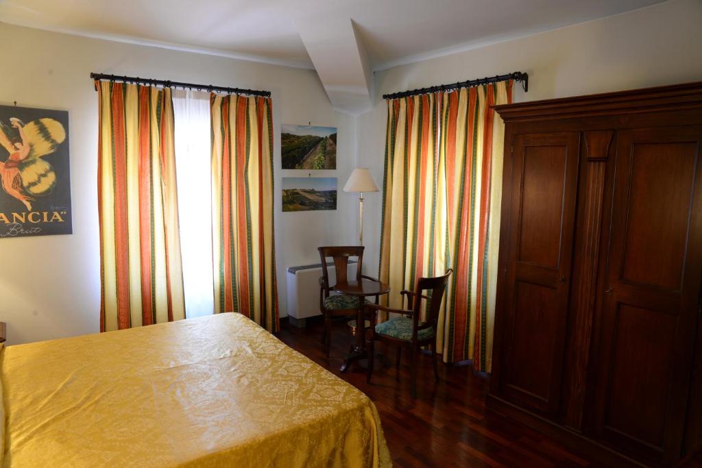Postel nebo postele na pokoji v ubytování Villa Chiara Hotel