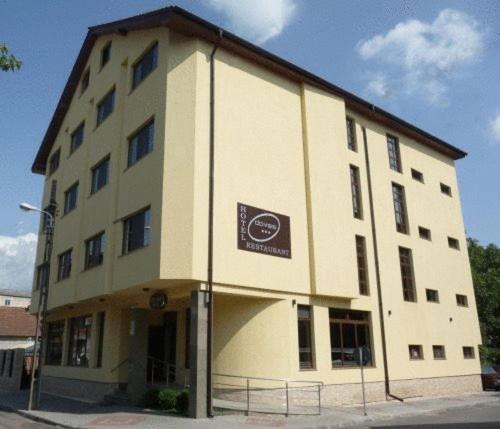 a large building with a sign on the side of it at Hotel Davos in Deva