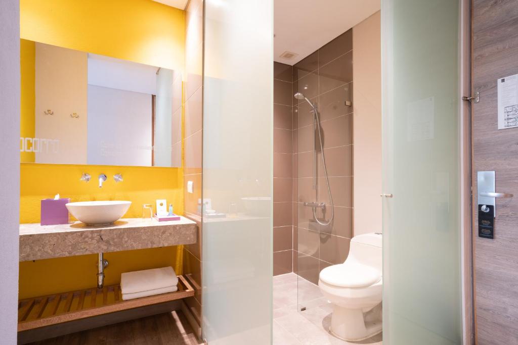 a bathroom with a sink and a toilet at Hotel Bari Bucaramanga in Bucaramanga