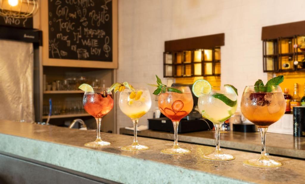 a row of wine glasses sitting on a bar at Hotel Bari Bucaramanga in Bucaramanga