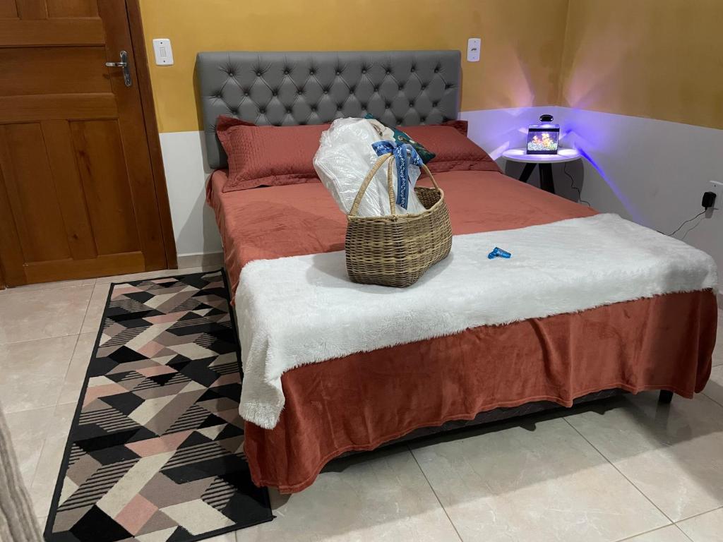 a bedroom with a bed with a basket on it at Flat hotel Victoram in Rio Branco