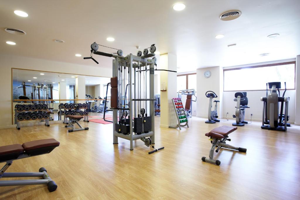 a gym with many exercise equipment in a room at Grupotel Parc Natural & Spa in Playa de Muro