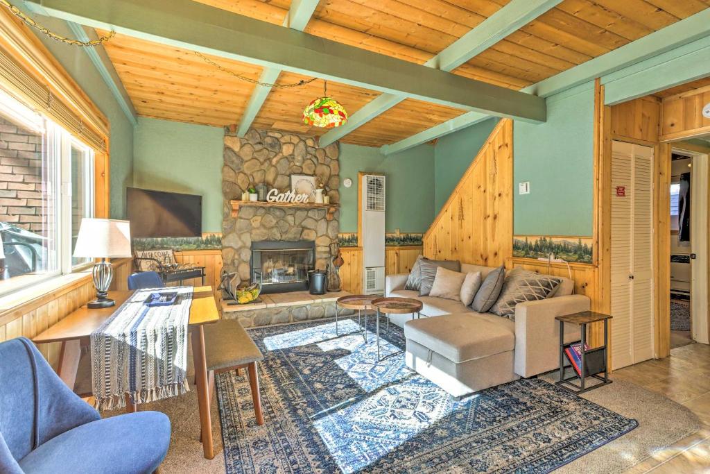 a living room with a couch and a fireplace at Cozy Big Bear Lake Cabin about 1 Mi to Skiing! in Big Bear Lake