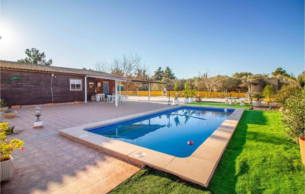 a swimming pool in the backyard of a house at Awesome Home In Molina De Segura With Kitchen in Molina de Segura