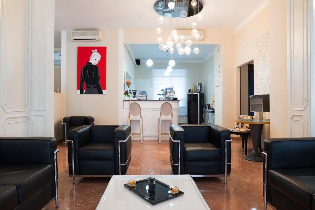 a waiting room with chairs and a table at Hotel Tourist in Turin