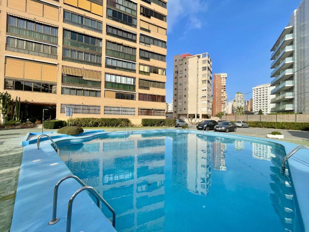 a large swimming pool in front of a building at Albaida Park Apartment in Benidorm