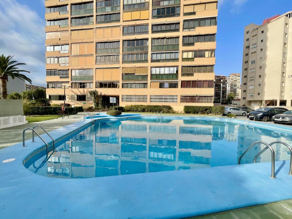 a large swimming pool in front of a building at Albaida Apartment in Benidorm