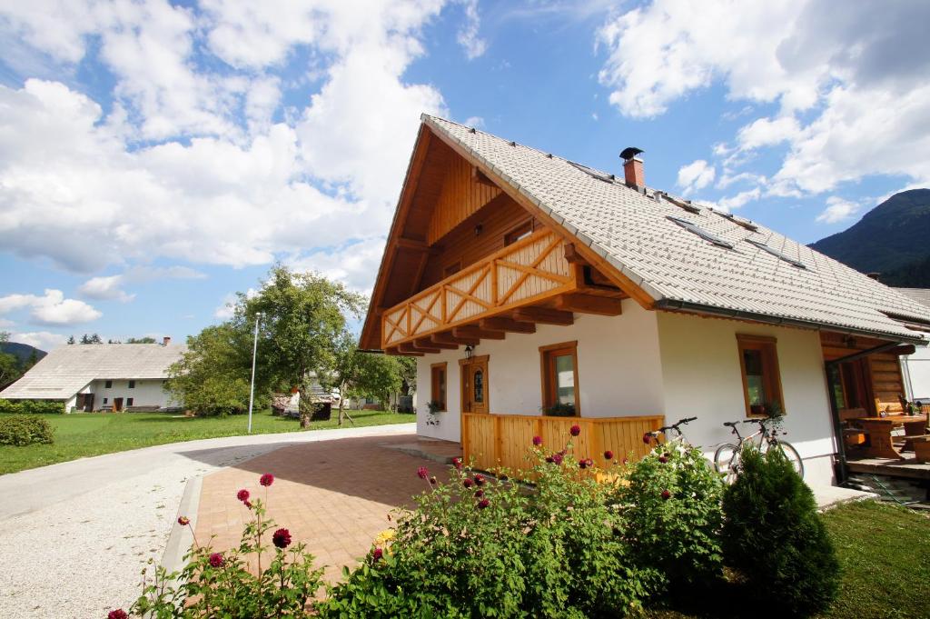 a small house with a wooden roof at Chalet Pr Dobravc in Bohinj