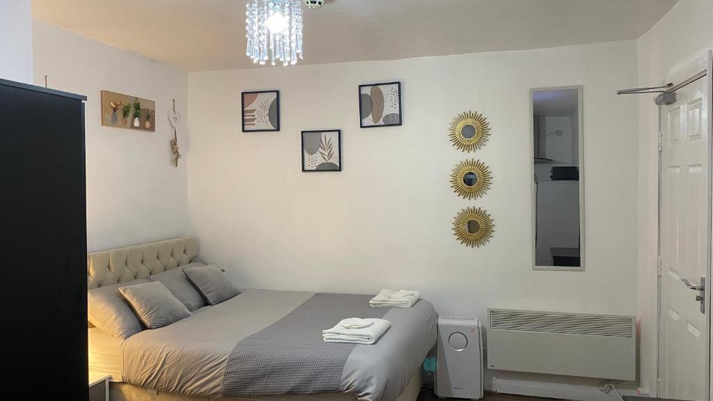 a bedroom with a bed and mirrors on the wall at BvApartments Queensgate 4 in Huddersfield