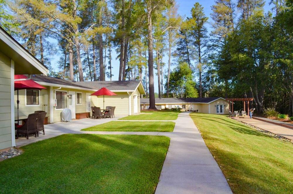 a yard of a house with a sidewalk and grass at Indian Creek Inn in Philo