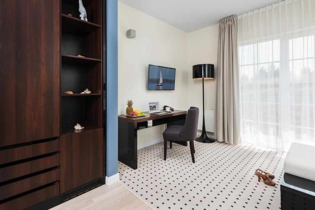Televízia a/alebo spoločenská miestnosť v ubytovaní Apartamenty M&M