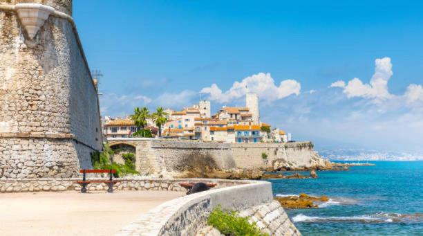 a group of houses on a hill next to the ocean at amazing new property in the heart of the old town of antibes in Antibes