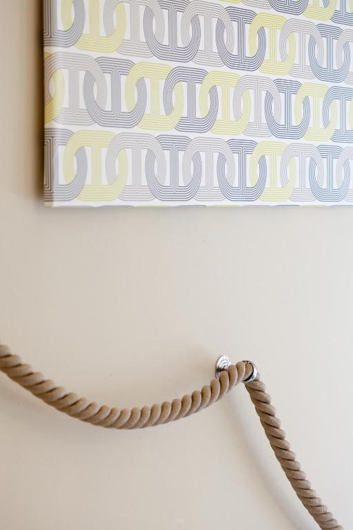 a rope hanging on a wall with a painting at Hotel Tourist in Turin
