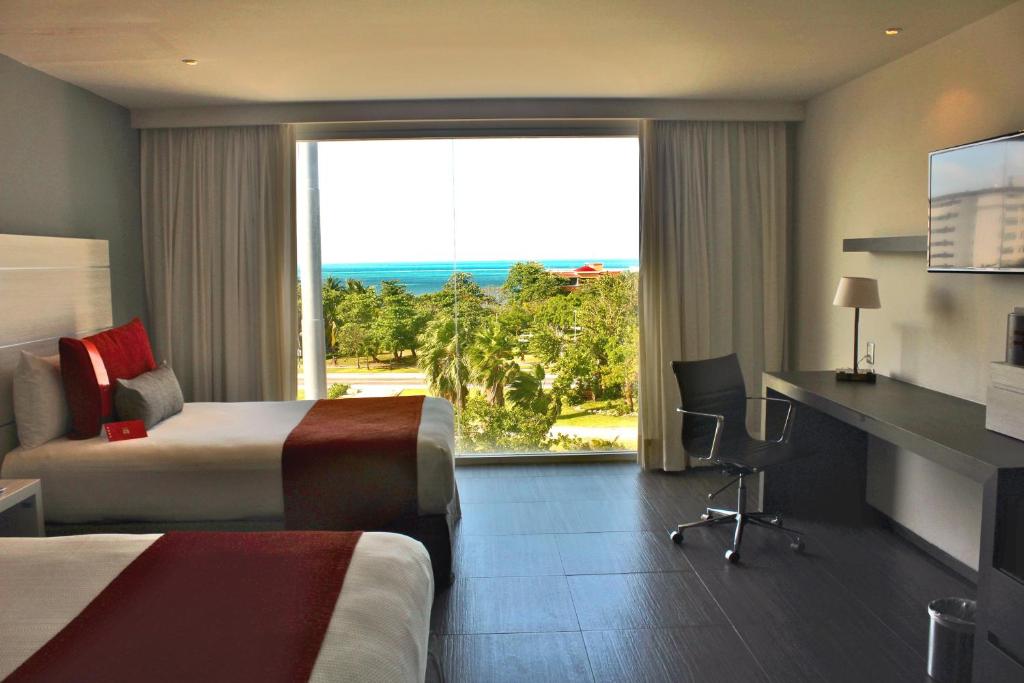 Postel nebo postele na pokoji v ubytování Real Inn Cancún