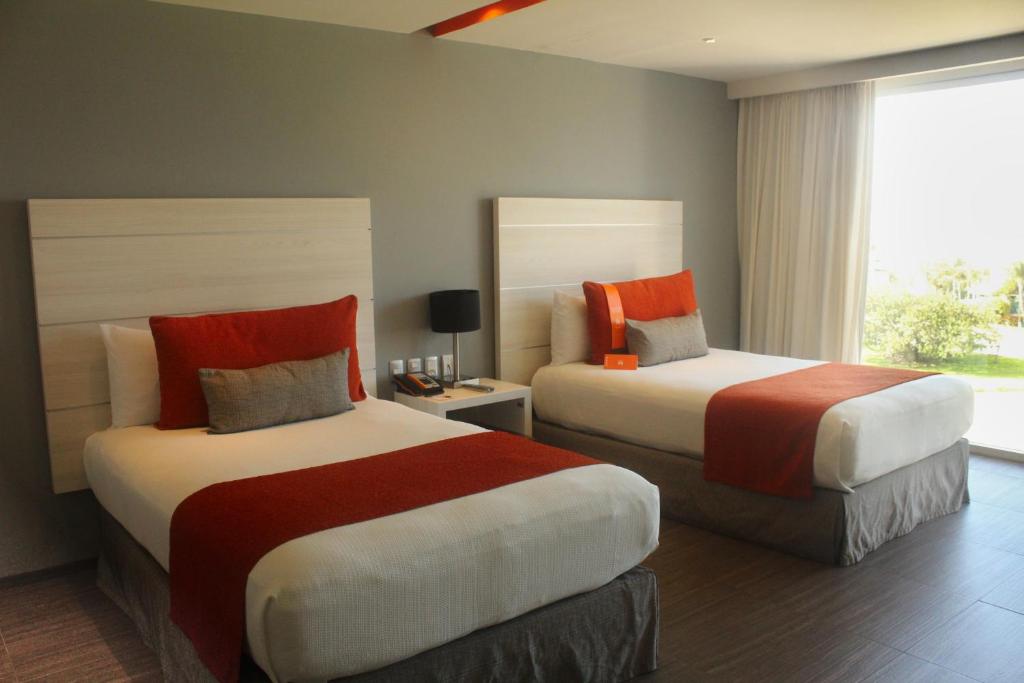 Postel nebo postele na pokoji v ubytování Real Inn Cancún
