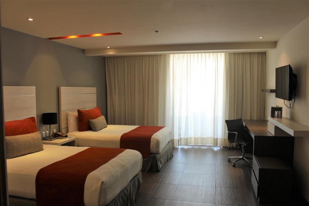Postel nebo postele na pokoji v ubytování Real Inn Cancún