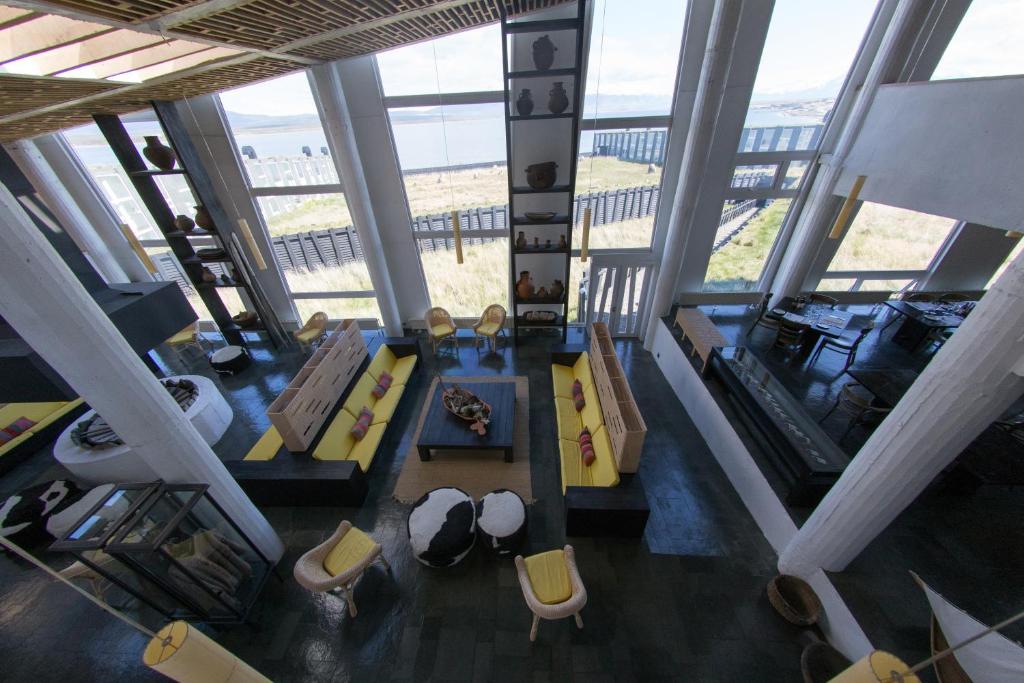an overhead view of a living room with yellow furniture at Remota Patagonia Lodge in Puerto Natales