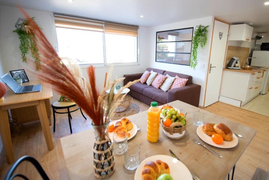 a living room with a table with food on it at KASA HOME - Calme, Cosy, WIFI & Netflix in Saint-Martin-la-Plaine