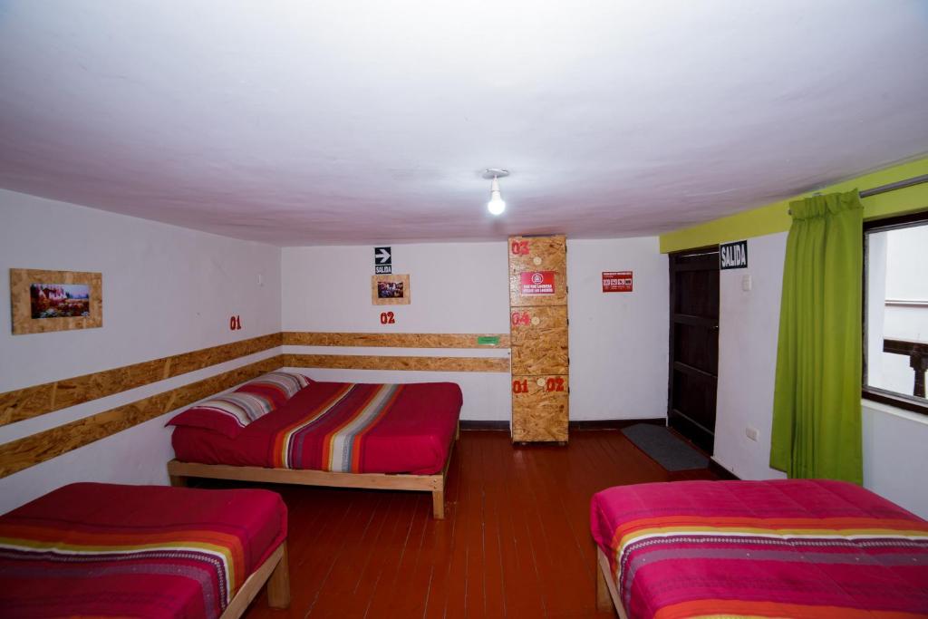 Postel nebo postele na pokoji v ubytování Ukukus Hostel