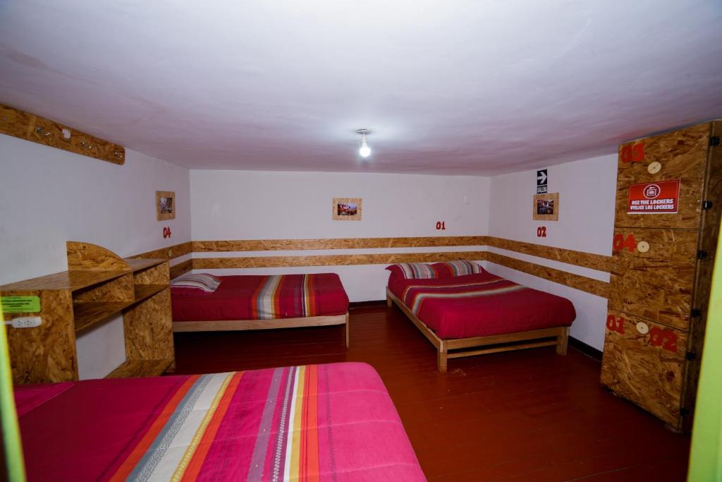 Postel nebo postele na pokoji v ubytování Ukukus Hostel