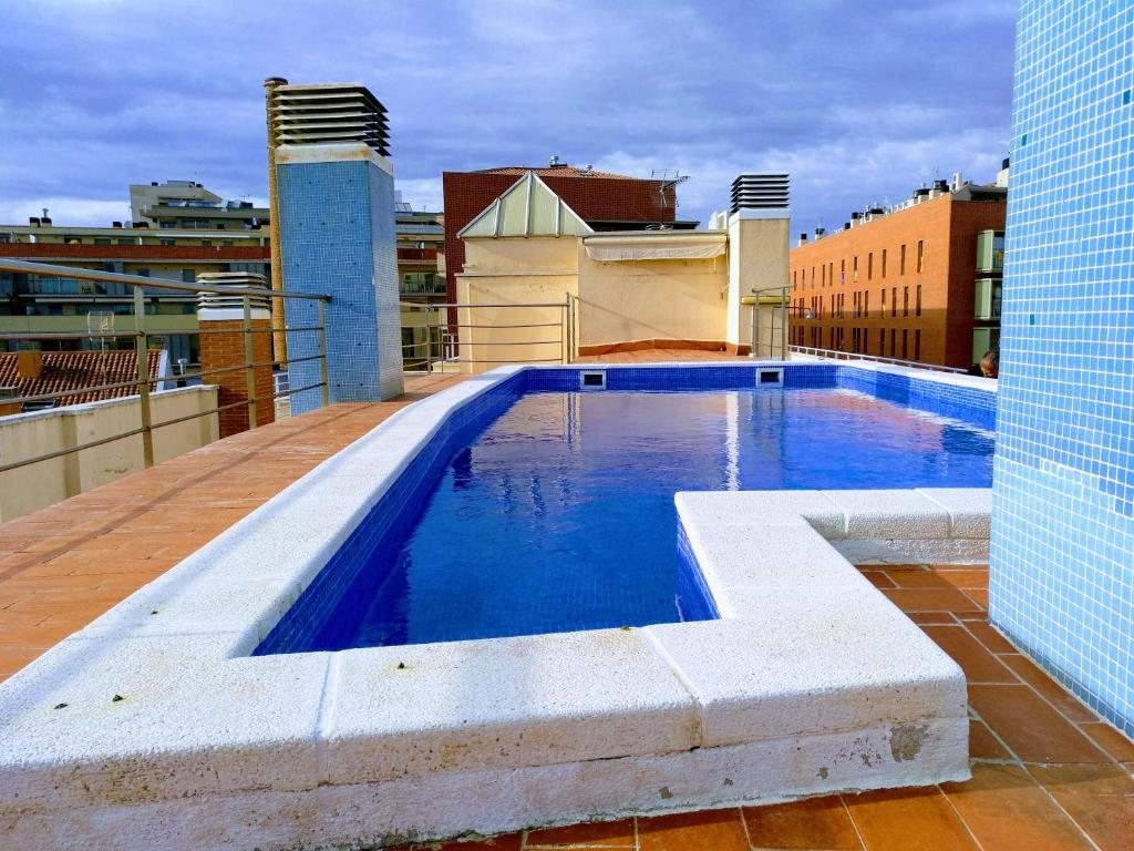 a swimming pool on the roof of a building at Piscina en Centro de Terrassa in Terrassa