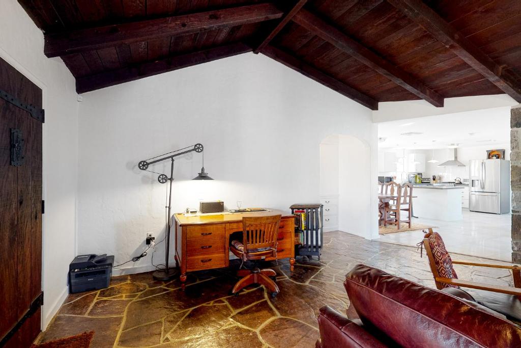 a living room with a desk and a kitchen at Lazy C Ranch in Tucson