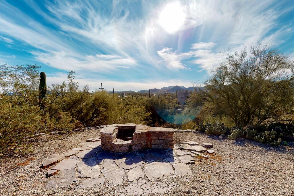 a stone fireplace in the middle of a field at Lazy C Ranch in Tucson