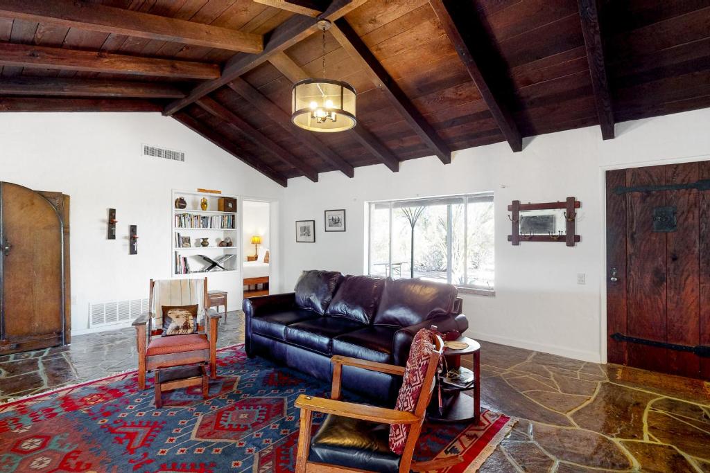 a living room with a leather couch and chairs at Lazy C Ranch in Tucson