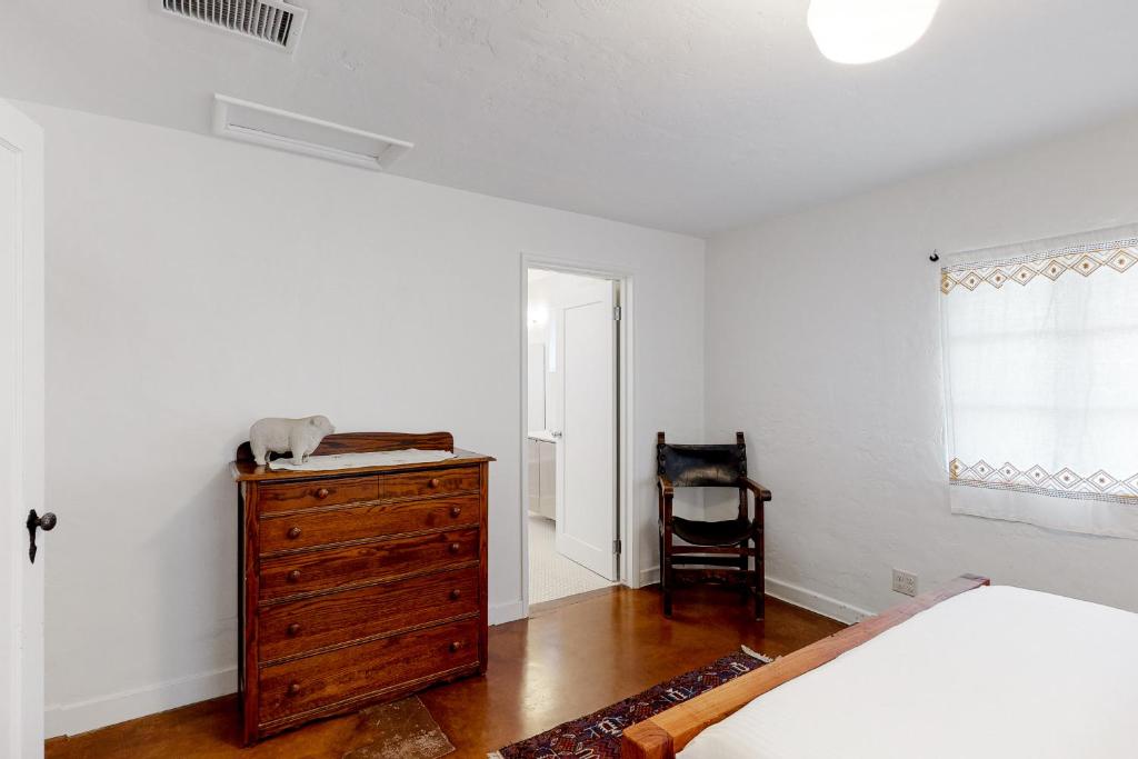 a bedroom with a bed and a dresser and a chair at Lazy C Ranch in Tucson
