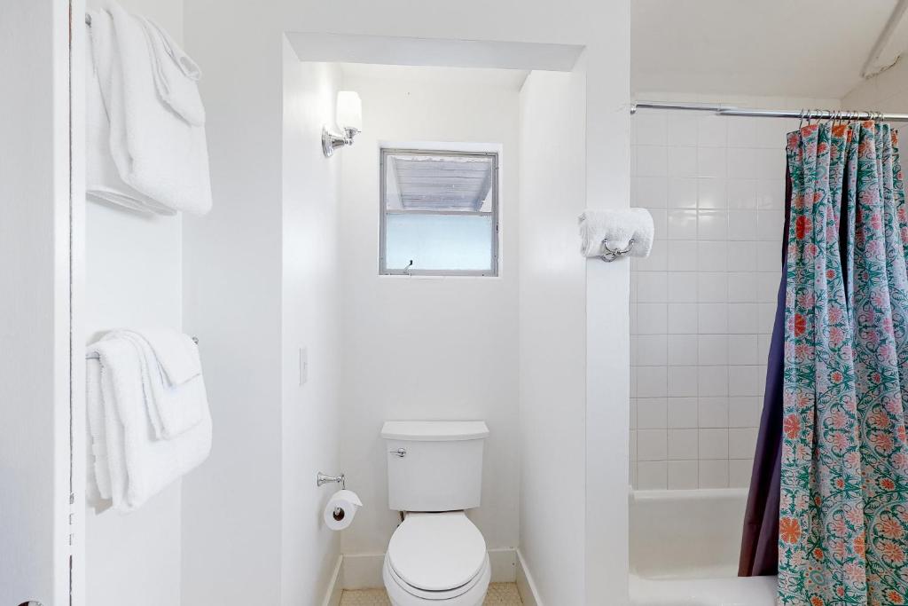 a white bathroom with a toilet and a shower at Lazy C Ranch in Tucson