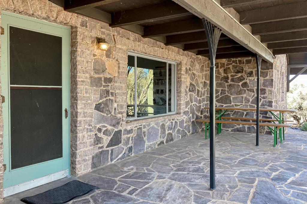 a stone building with a door and a window at Lazy C Ranch in Tucson