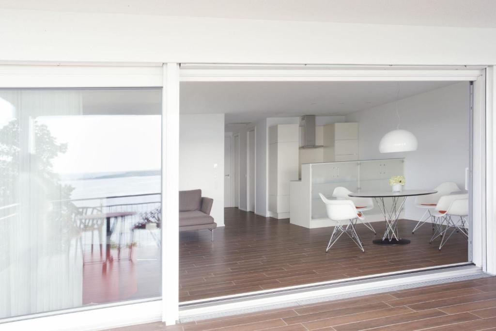 a living room and dining room with a sliding glass door at Ferienwohnungen Stella Regia Stella Regia 1 in Meersburg