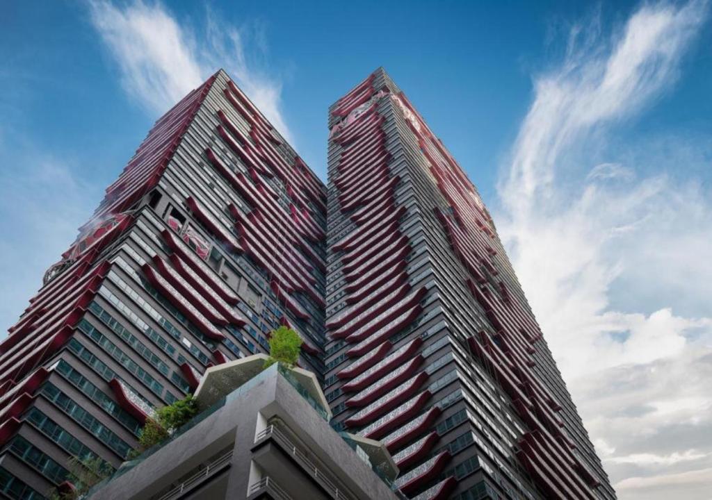 two tall skyscrapers in front of a blue sky at LIV Signature Arte Plus in Kuala Lumpur