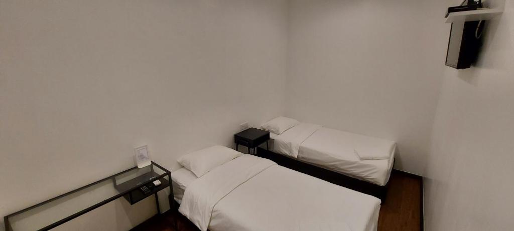 Postel nebo postele na pokoji v ubytování Olive Bedz Hotel