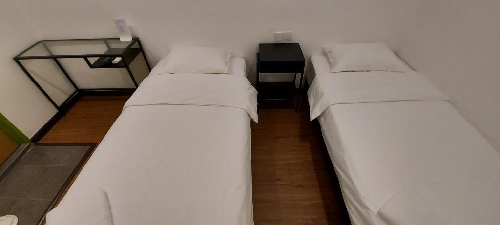Postel nebo postele na pokoji v ubytování Olive Bedz Hotel