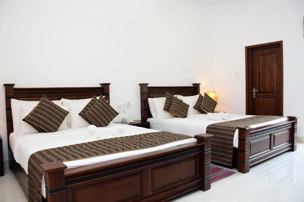 Postel nebo postele na pokoji v ubytování Hotel Bamiyan