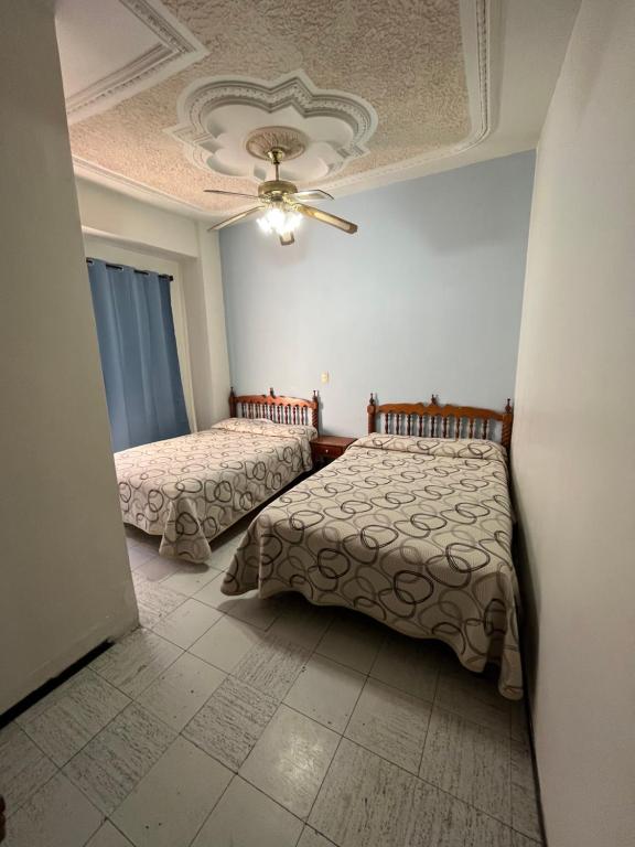 Postel nebo postele na pokoji v ubytování Hotel Paris