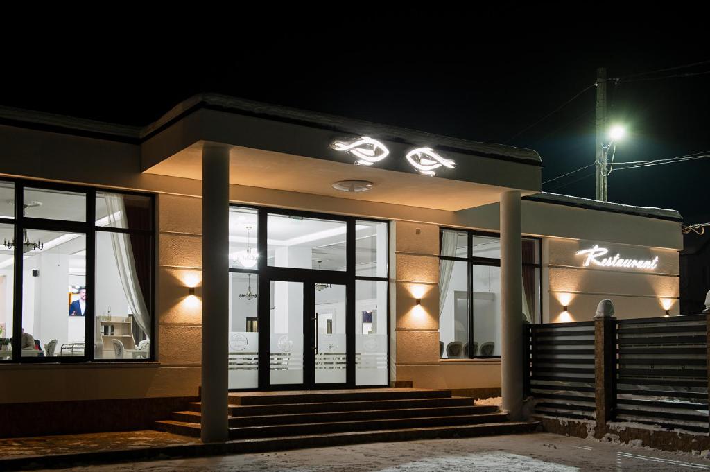 a building with lights on it at night at Complex Pescăresc Gura Repezii Borșa in Borşa