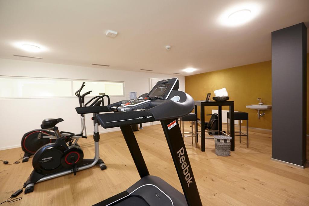 a room with a gym with a treadmill and exercise equipment at Hotel AVA in Sempach Station