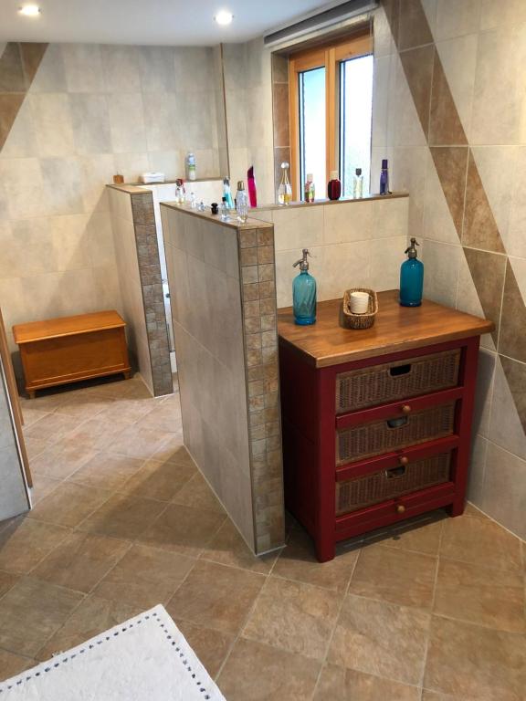 a bathroom with a sink and a wooden cabinet at Albergo Diffuso Porrentruy in Porrentruy