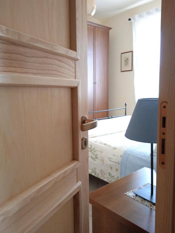 a door leading to a bedroom with a bed at La Casetta in Piazza in Pincara