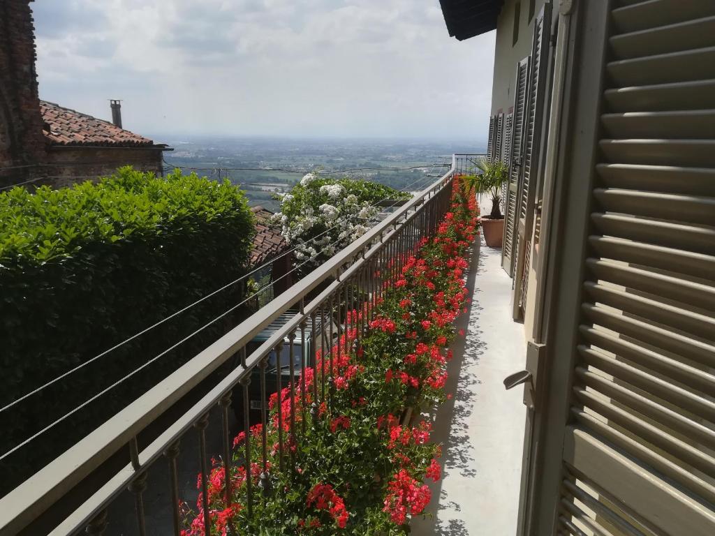 un balcone con fiori sul lato di un edificio di A CASA DI CARLA B&B a San Raffaele Cimena