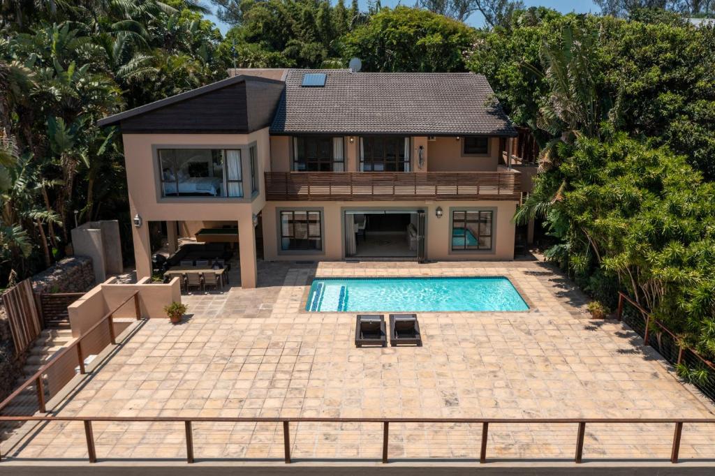 an aerial view of a house with a swimming pool at The Fairways, Ballito in Sheffield Beach