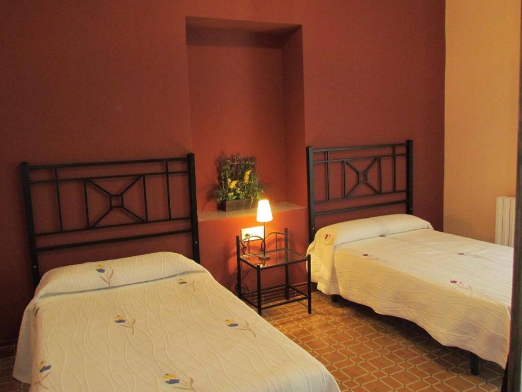 Cama o camas de una habitación en Hostal Las Rumbas