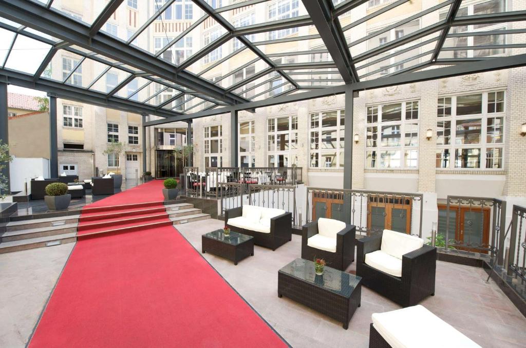 a building with a red carpet and chairs and a red rug at Wyndham Garden Berlin Mitte in Berlin