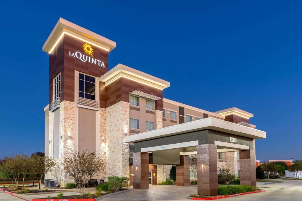 a hotel with a sign on the front of a building at La Quinta by Wyndham Houston NW Beltway8/WestRD in Houston