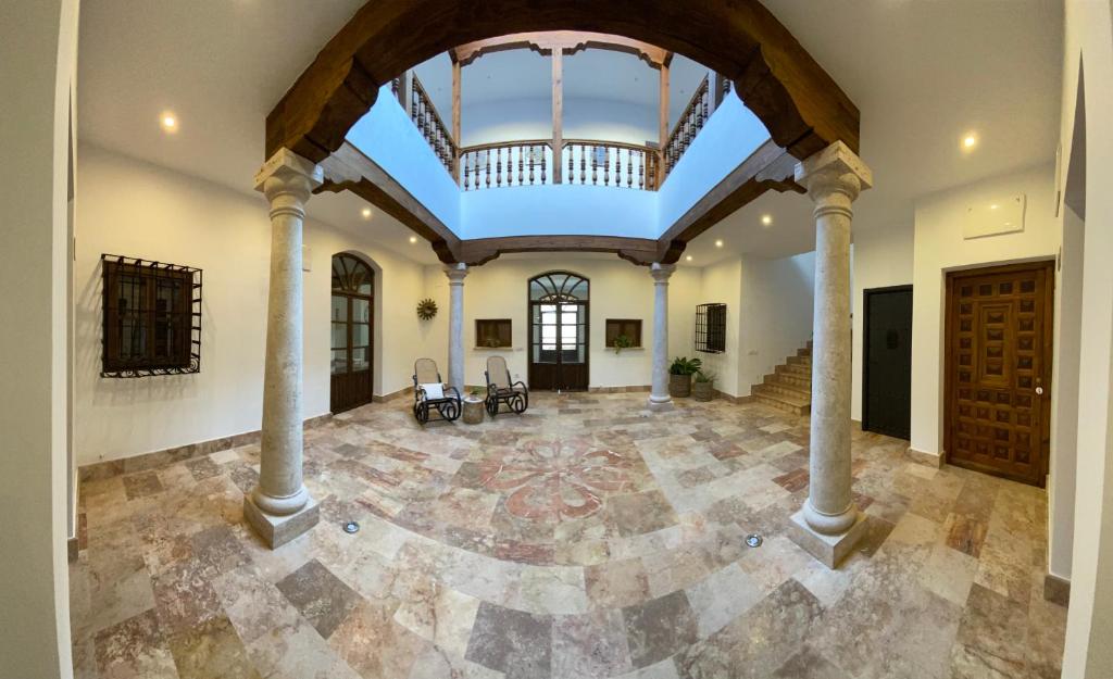 a large room with columns and a large ceiling at Casa Elsa Almagro in Almagro