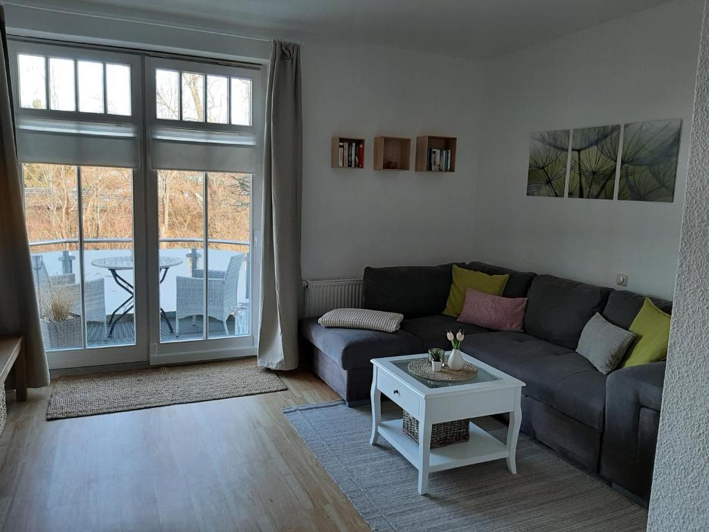 a living room with a couch and a table at Fewo Bernhardt " App.1 " in Scharbeutz