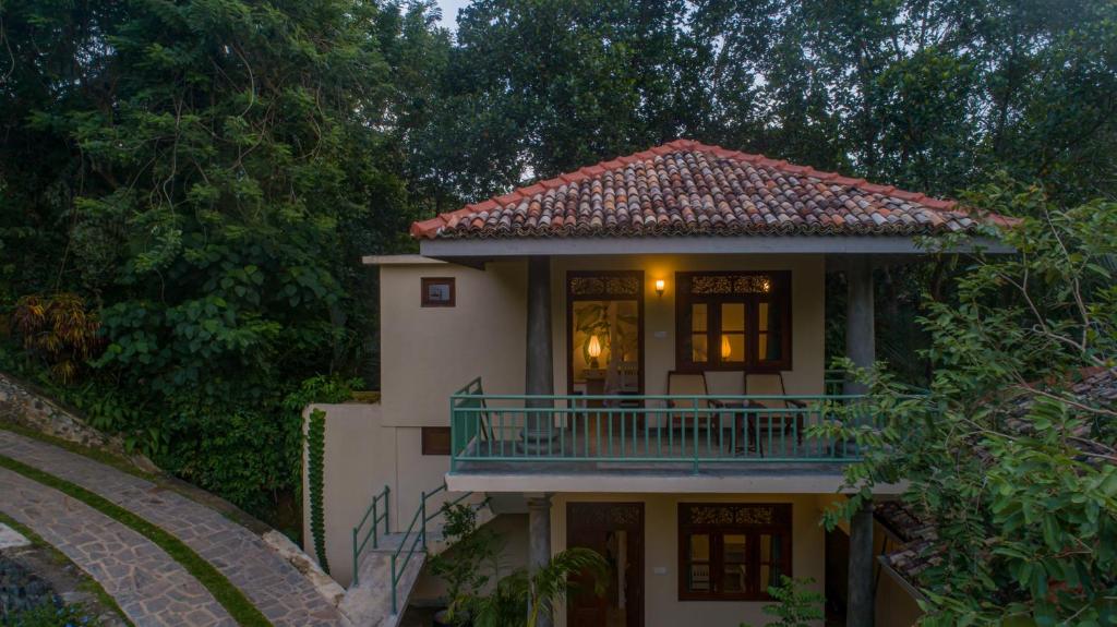 a house with a balcony on the side of it at Green Escape Unawatuna in Unawatuna