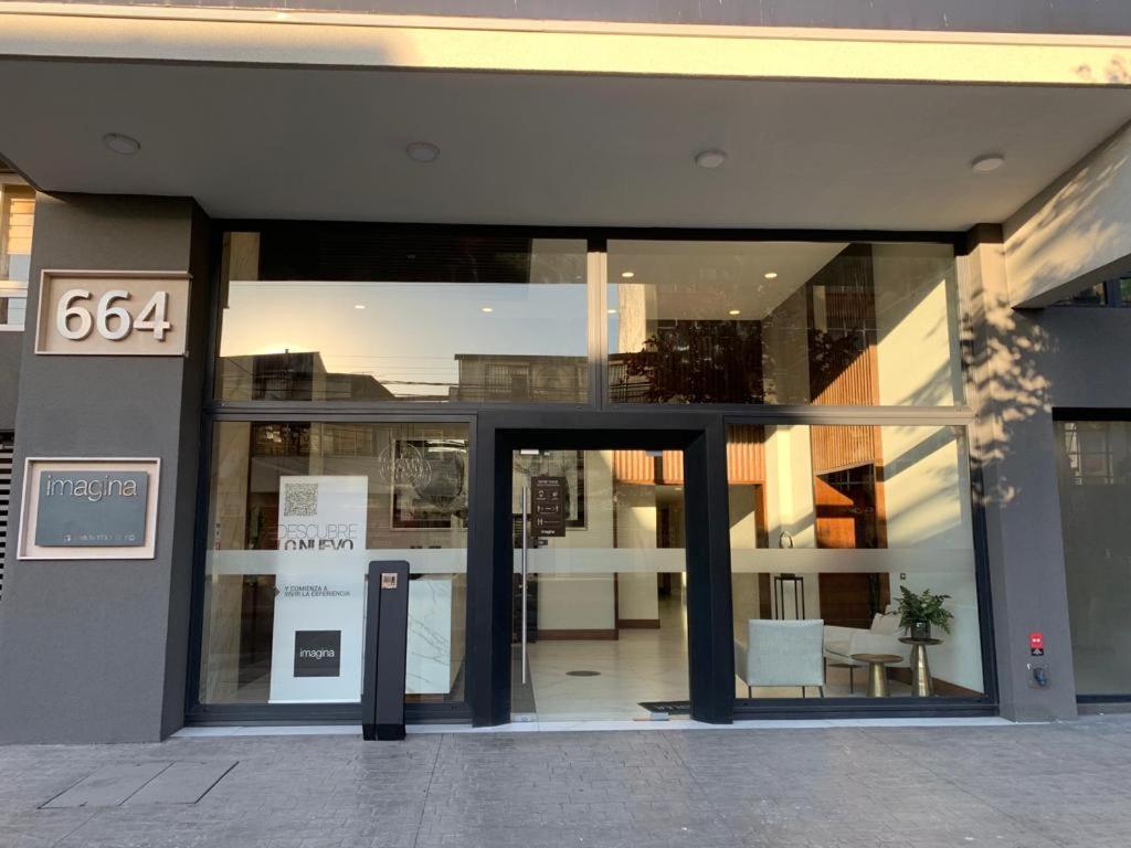 a building with an open door with a sign on it at Apartamentos Concepción Centro in Concepción